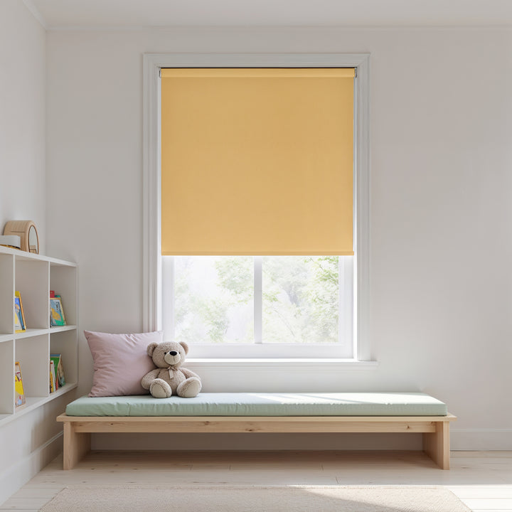 Yellow roller blind on a window with a wooden bench and teddy bear in a room.