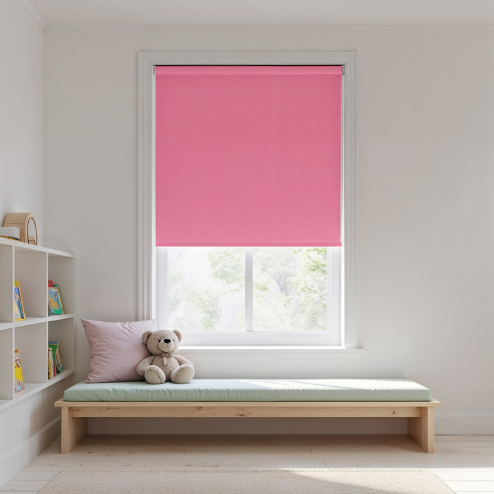 Window with pink roller blind, wooden bench, and teddy bear in a room.
