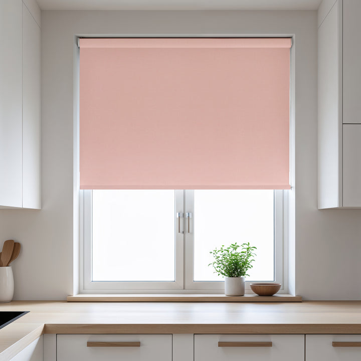 Pink roller blind on a window in a kitchen setting