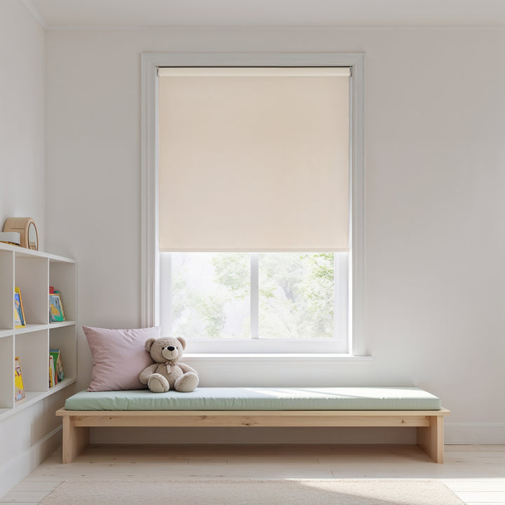 Window with beige roller blind, wooden bench with cushion, and teddy bear in a room.
