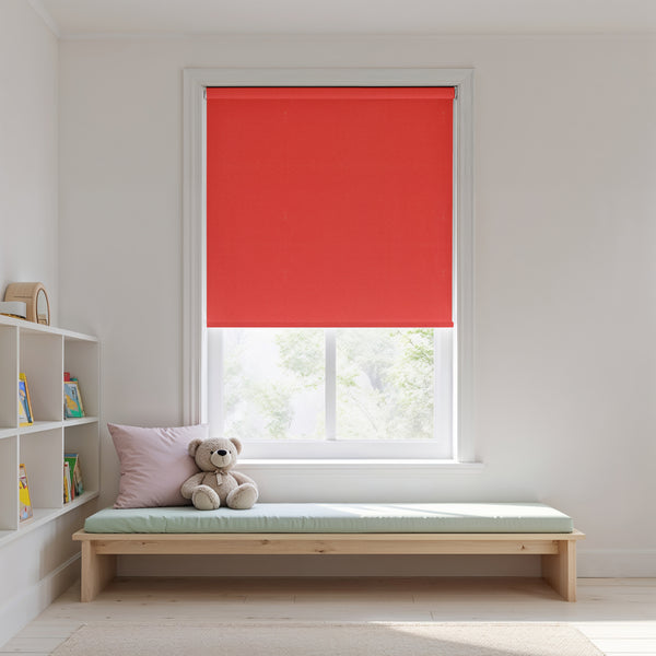 Red roller blind on a window with a wooden bench and teddy bear in a room.
