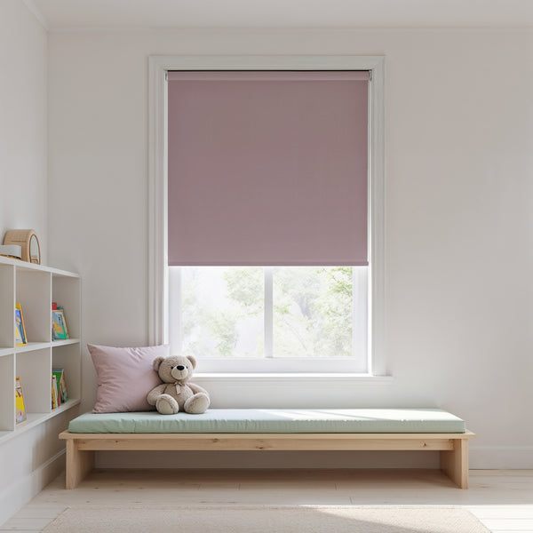 Window with pink roller blind, wooden bench with cushion, and teddy bear in a room.