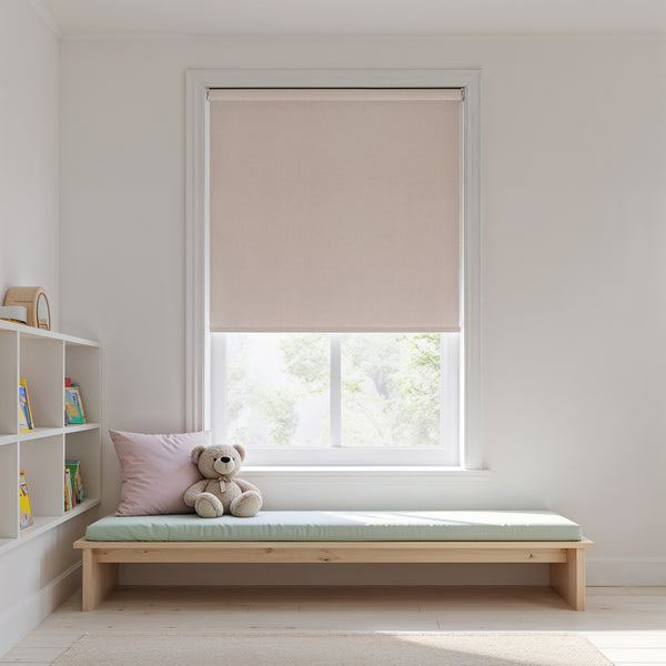 Beige roller blind on a window with a wooden bench and teddy bear in a room.